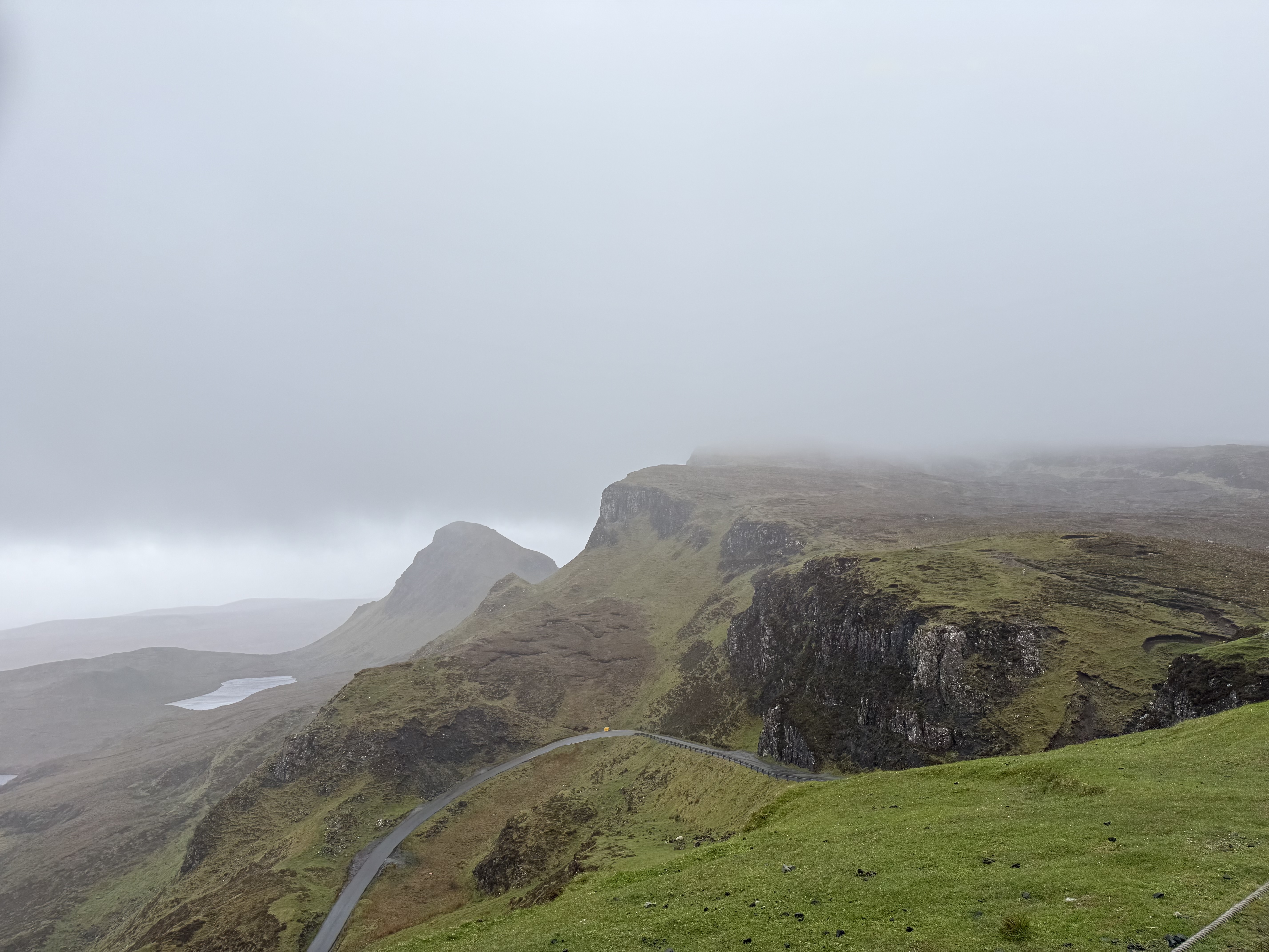 The winding road through the Quiraing, mist rolling in